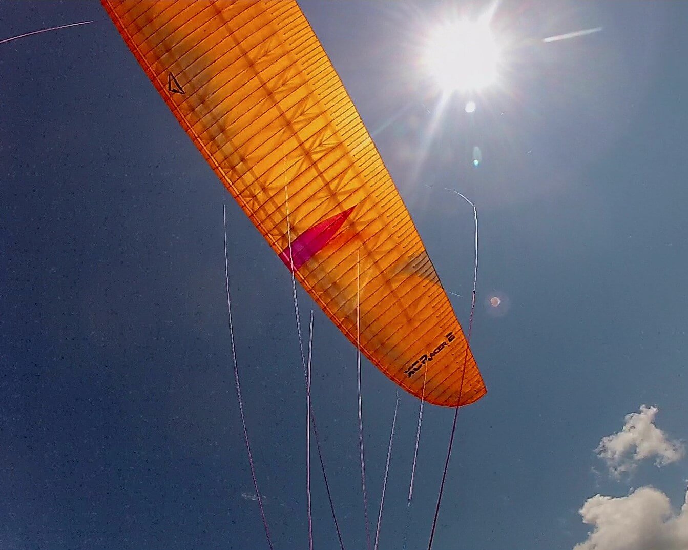 Paraglider Flow XC Racer 2 in orange color, folded neatly in a concertina, ready for sale