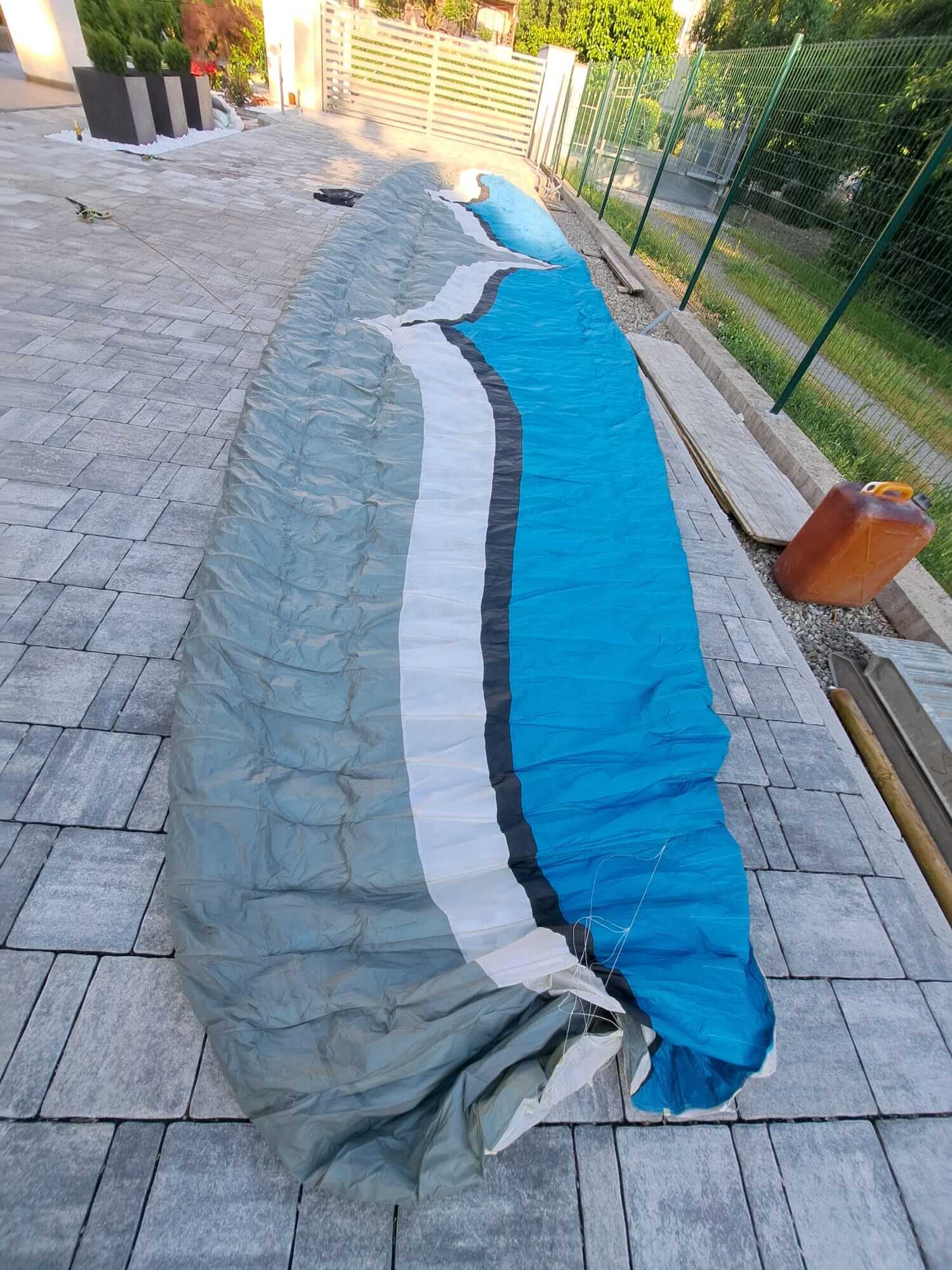 Front view of an Ozone Mantra M7 paraglider in flight, size MS, used high-performance EN D wing for sale in Parma, Italy.