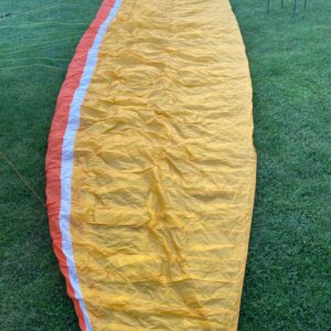 Golden Nova Mentor 4 paraglider laid out on grassy field, ready for flight – excellent condition, EN B+ wing for sale.