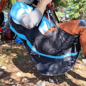 Woody Valley Wani Light harness in XL size, shown in rucksack mode on a clean surface, used for hike and fly adventures.