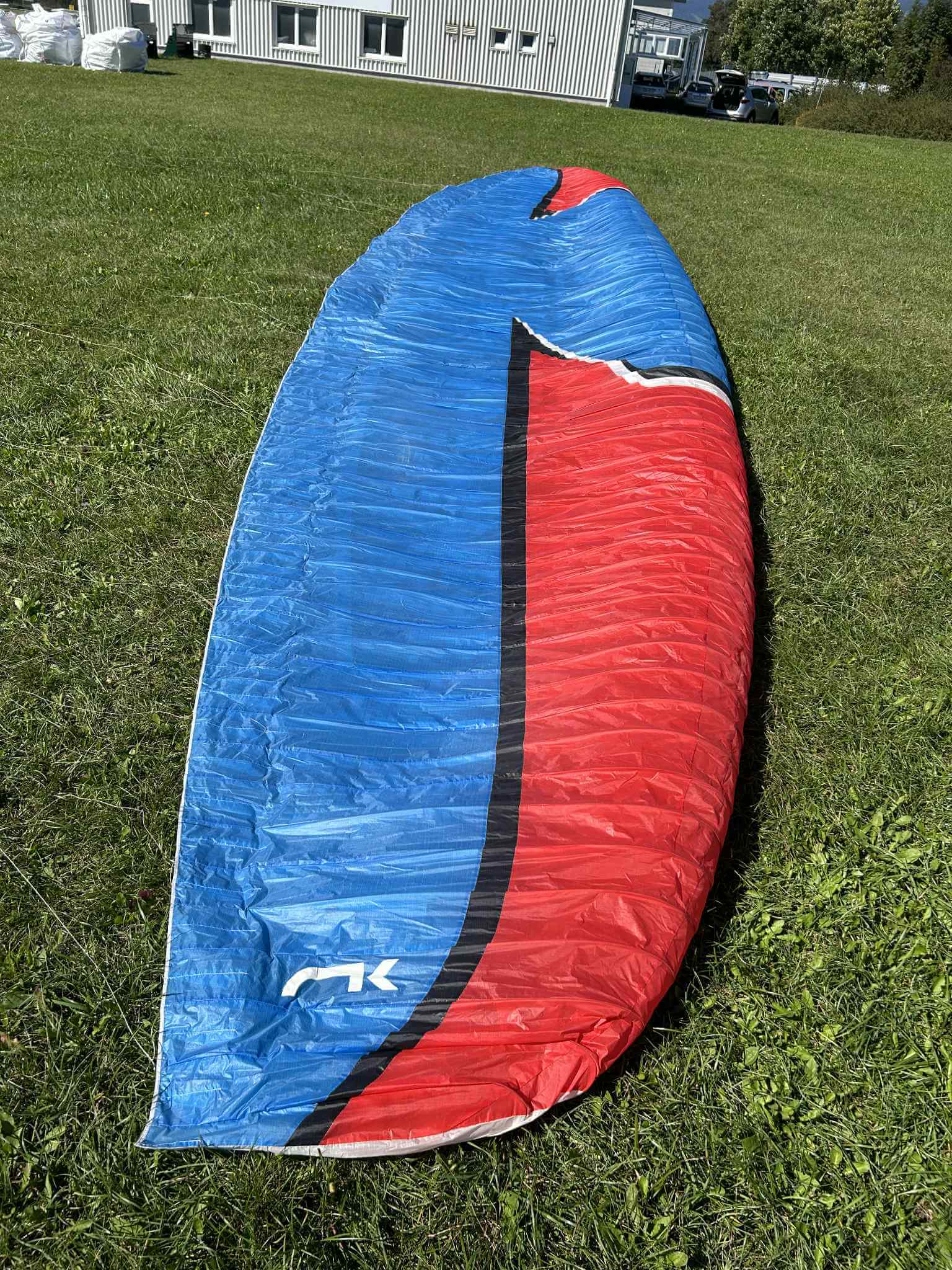 Front page photo of Niviuk Icepeak Evox 2 race paraglider in blue and red colors, size 24, second-hand wing for sale in Slovenia.