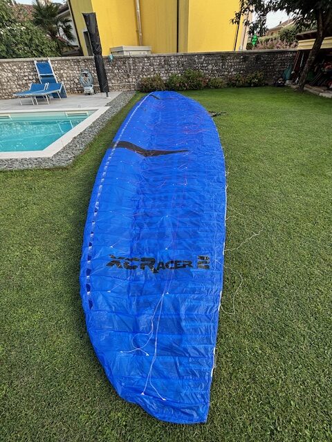 Flow XC Racer 2 paraglider in blue color during XC flight, high-performance EN D 2-liner wing for long cross-country adventures.