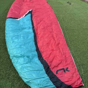Used Niviuk Ikuma 2 paraglider red and blue, size 24, in very good condition for sale in Spain, ideal for intermediate pilots aiming for first XC flights