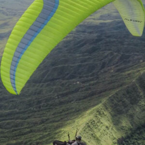 Ozone Alpina 4 paraglider laid out on mountain slope ready for hike and fly adventure, lightweight wing for sale in Spain, good condition used paraglide