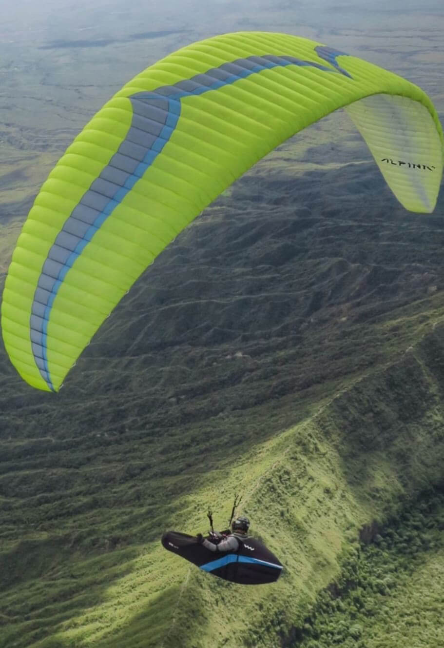 Ozone Alpina 4 paraglider laid out on mountain slope ready for hike and fly adventure, lightweight wing for sale in Spain, good condition used paraglide