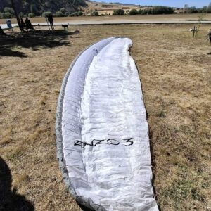 Ozone Enzo 3 paraglider in very good condition, ready for competition and long XC flights, photographed during setup on takeoff.