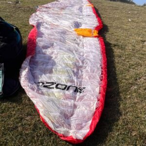 Ozone Zeno 2 red and yellow paraglider laid out for preflight check in Tarragona, Spain